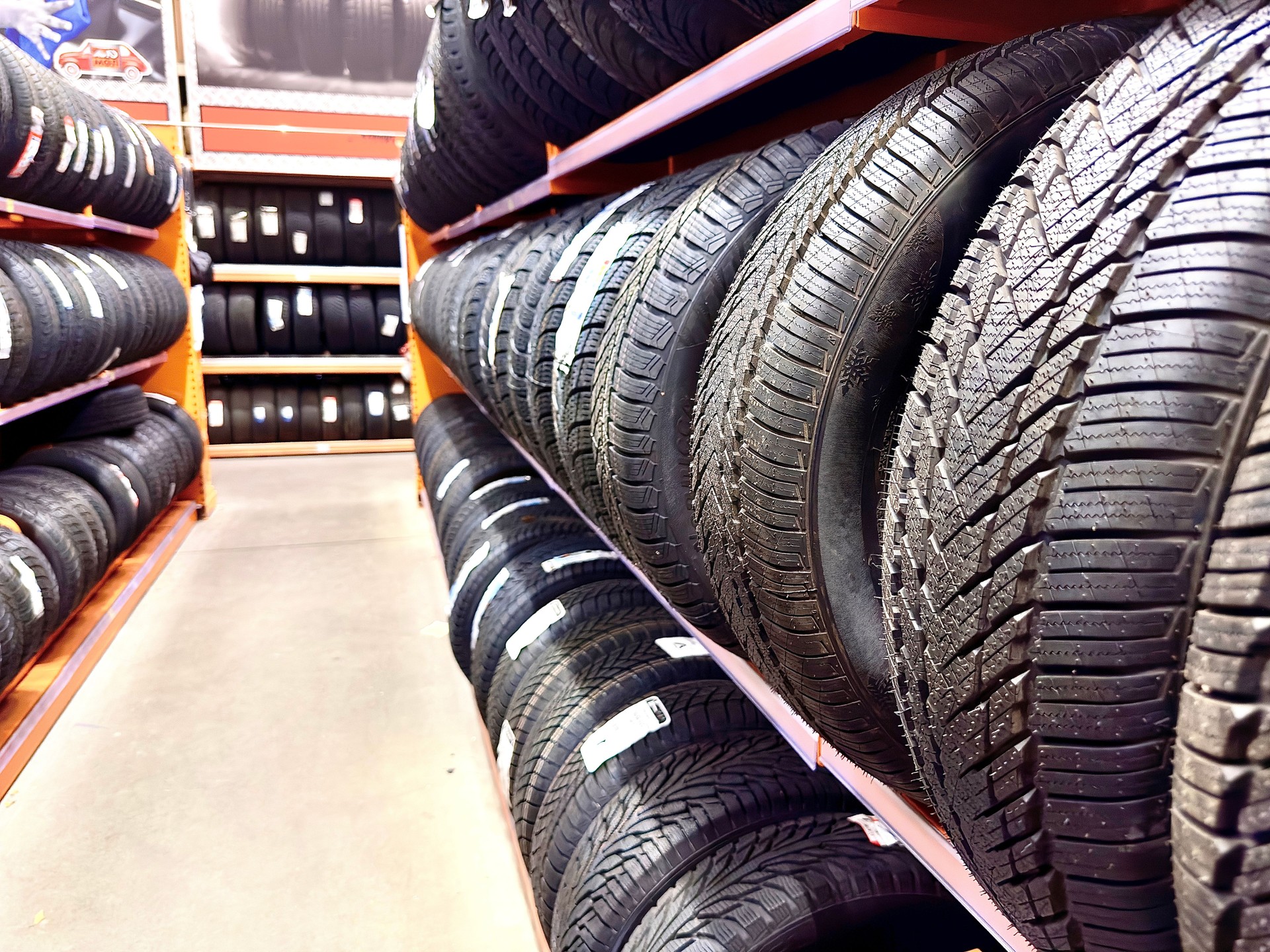 Car tires on the shelves in a car shop. Car shop.